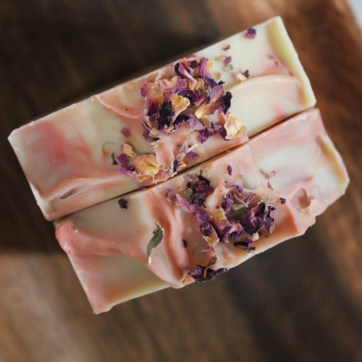 All natural Lavender Rose soap photographed from above embellished with rose petals on top.